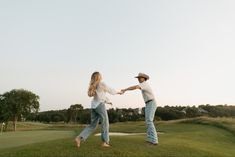 Engagement photo couple session cowboy hat engagement ring golf course wrangler jeans kissing sunset hugging photography white fence dancing Low Country Engagement Photos, Golf Course Engagement Photoshoot, Southern Couple, Engagement Vibes, Western Couple, Country Engagement