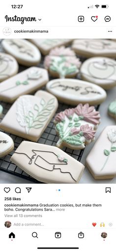 some cookies are on a cooling rack and one is decorated with frosted icing