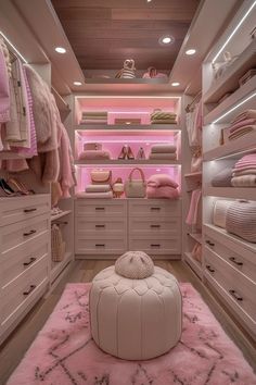 a walk in closet filled with lots of pink furniture and accessories, including a round ottoman