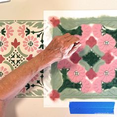 an older woman is working on a painting with acrylic paint and paper flowers