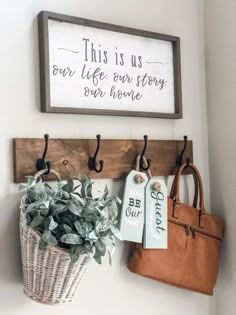 this is us our life our story our home hanging on the wall next to a potted plant