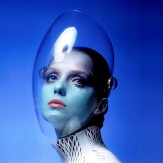 a woman's face is covered in blue and white paint, as if it were an alien