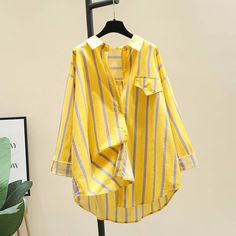 Our stylish Vertical Striped Button-Down Blouse is perfect for any occasion! Get ready to turn heads at work or on the town. The vertical stripes will add an extra dimension of sophistication to your outfit and is available in three different colors. Striped Cotton V-neck Blouse, Striped Cotton Blouse With Buttons, Yellow Cotton V-neck Shirt, Striped Long Sleeve Blouse For Daywear, Trendy Striped Blouse For Daywear, Striped Long Sleeve Top For Daywear, Long Sleeve Blouse With Roll-up Sleeves For Daywear, Yellow Cotton Long Sleeve Blouse, Multicolor Cotton Blouse For Work