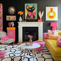 a living room filled with furniture and art on the wall above a fire place in front of a fireplace