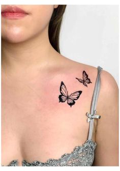 a woman's chest with two butterflies on her left shoulder and the upper part of her right arm