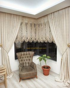 a chair sitting in front of a window next to a potted plant