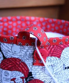 a close up of a red and white basket with an animal design on it's side