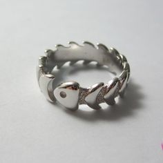 Dive into a unique style with our Silver Fishbone Ring, meticulously handcrafted to resemble a fish skeleton. Handmade in Greece- Free Worldwide Shipping- Large Variety of Rings This quirky and eye-catching piece is perfect for ocean lovers and those who appreciate unique, nature-inspired jewelry. This delicate fish ring is perfect for stacking with other rings or wearing on its own. Crafted from high-quality 925 stering silver, this ring is designed to be adjustable, ensuring a comfortable fit Weird Rings, Fish Rings, Skeleton Band, Nature Inspired Fashion, Fish Skeleton, Fish Ring, Silver Jewlery, Unusual Rings, Unique Nature