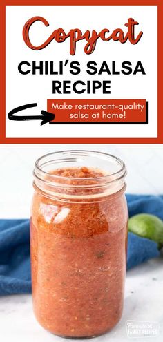 a jar filled with chili sauce sitting on top of a counter next to a blue towel