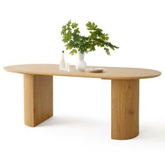 a wooden table with two vases and a plant on it's top, against a white background