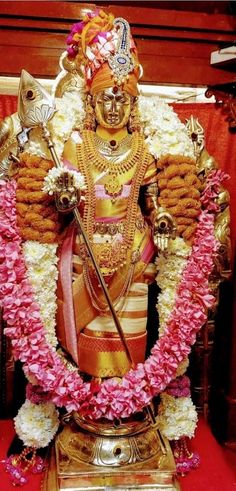 the statue is decorated with flowers and other decorations