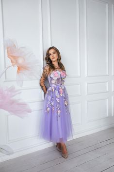 Feel like a fairy tale princess in our dreamy purple floral dress!  With delicate flower appliques, a flowy midi length,  and lace detailing on the back, this dress is perfect for weddings,  proms, or photo sessions.  And the best part? Bow ties on the shoulders add a touch of romance  and playfulness to this enchanting dress. Message me for any kind of customizations. Princess Style Floral Applique Prom Dress, Princess Style Prom Dress With Floral Applique, Lavender Dress For Wedding And Prom Season, Purple Dresses For Wedding And Prom Season, Spring Prom Princess Evening Dress, Purple Lace Dress With Sweetheart Neckline, Purple Dresses For Prom Season, Lavender Dresses For Prom Season, Purple Tulle Dress For Wedding