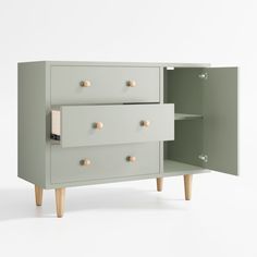 a green cabinet with three drawers and two wooden legs on the bottom one drawer is open