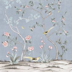 two birds sitting on top of a tree in front of some flowers and branches with blue sky