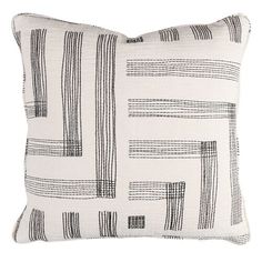 a black and white pillow with lines on the front, along with a square shape