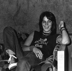 a black and white photo of a person sitting on a couch