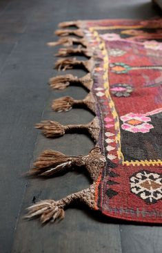 an old rug with tassels on it