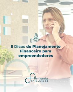 a woman talking on her cell phone while sitting at a table with a potted plant