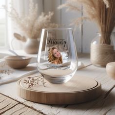 a wine glass sitting on top of a wooden coaster