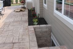 an outside view of a house with flowers in the front yard