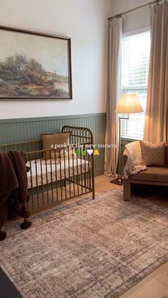 a living room filled with furniture and a baby crib in front of a window