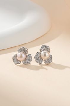 5-5.5mm Cubic Zirconia Floral Pearl Earrings Experience the elegance of our 5-5.5mm Cubic Zirconia Floral Pearl Earrings. With 3 cubic zirconia petals and a freshwater button pearl, these floral ear studs are the perfect combination of sophistication and beauty. Made with 925 sterling silver, these earrings are sure to be a timeless addition to any jewelry collection. Enjoy a touch of luxury with every wear. Product Details Material: 925 Sterling Silver Pearl Type: Freshwater Pearls Pearl Size: Golden South Sea Pearls, Mabe Pearl, Pearl Necklace Earrings, Purple Pearl, Pearl Types, Pearl Gemstone, Product Introduction, Floral Earrings, Pearl Size