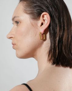 The much-loved classic hoops get an edgy upgrade with these folded rectangular hoop earrings, an ode to simplistic style statements using deconstructed geometry. Slim posts give this subversive-basic design effortless wearability, perfect for your newest Ear Party look.

Size: 24.5x22mm
Material: 18k Gold Plated On Brass Modern Hoop Earrings With Rectangular Links, Modern Rectangular Huggie Earrings, Modern Hoop Earrings With Rectangular Links For Everyday, Minimalist Square Huggie Earrings For Everyday, Minimalist Square Hoop Earrings For Everyday, Modern Square Hoop Earrings For Everyday, Simplistic Style, Ear Party, Open Hoop Earrings