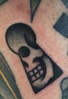 a close up of a person's arm with a skull on it