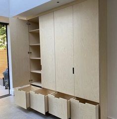 an empty room with wooden cabinets and sliding glass doors