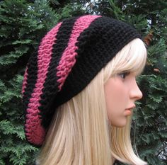 a mannequin head wearing a black and pink knitted hat with stripes on it