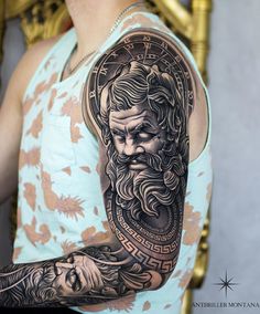 a man with a large tattoo on his arm