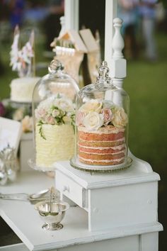 a table topped with lots of cakes covered in frosting