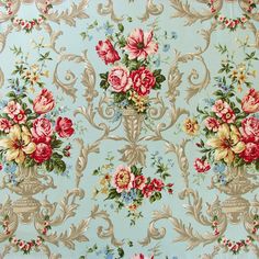 a blue wallpaper with pink and red flowers in vases on top of it