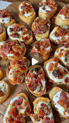 small appetizers with various toppings are arranged in a circle on a table