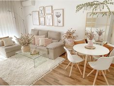 a living room filled with lots of furniture and decor on top of a hard wood floor