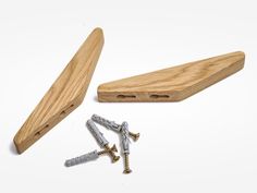 three screws and two wooden case on a white background