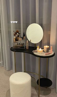 a vanity with a mirror and candles on it