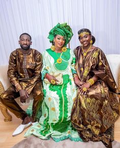 two men and a woman dressed in african clothing