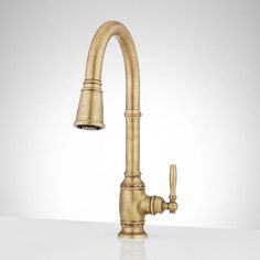 an antique brass faucet is shown on a white surface