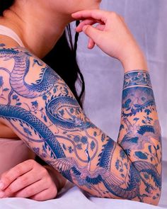 a woman with dragon tattoos on her arm