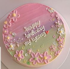 a birthday cake decorated with flowers and butterflies