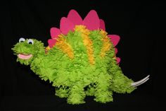 a green and pink stuffed animal that looks like a flower