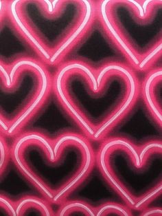 a pink and black background with hearts on it