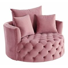 a pink couch with pillows on it and some pillows in the shape of an oval