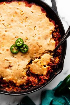 a casserole dish with green peppers on top