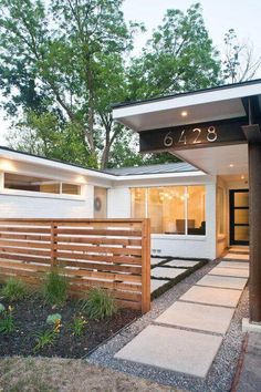 a modern house with an entry way leading to the front door