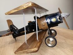 an old model airplane on a wooden table