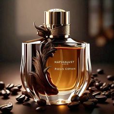 a bottle of perfume sitting on top of coffee beans