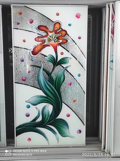 a decorative glass window with a flower on it's side and bubbles in the background