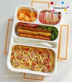 the meal is ready to be eaten in the lunch box, with noodles and meats